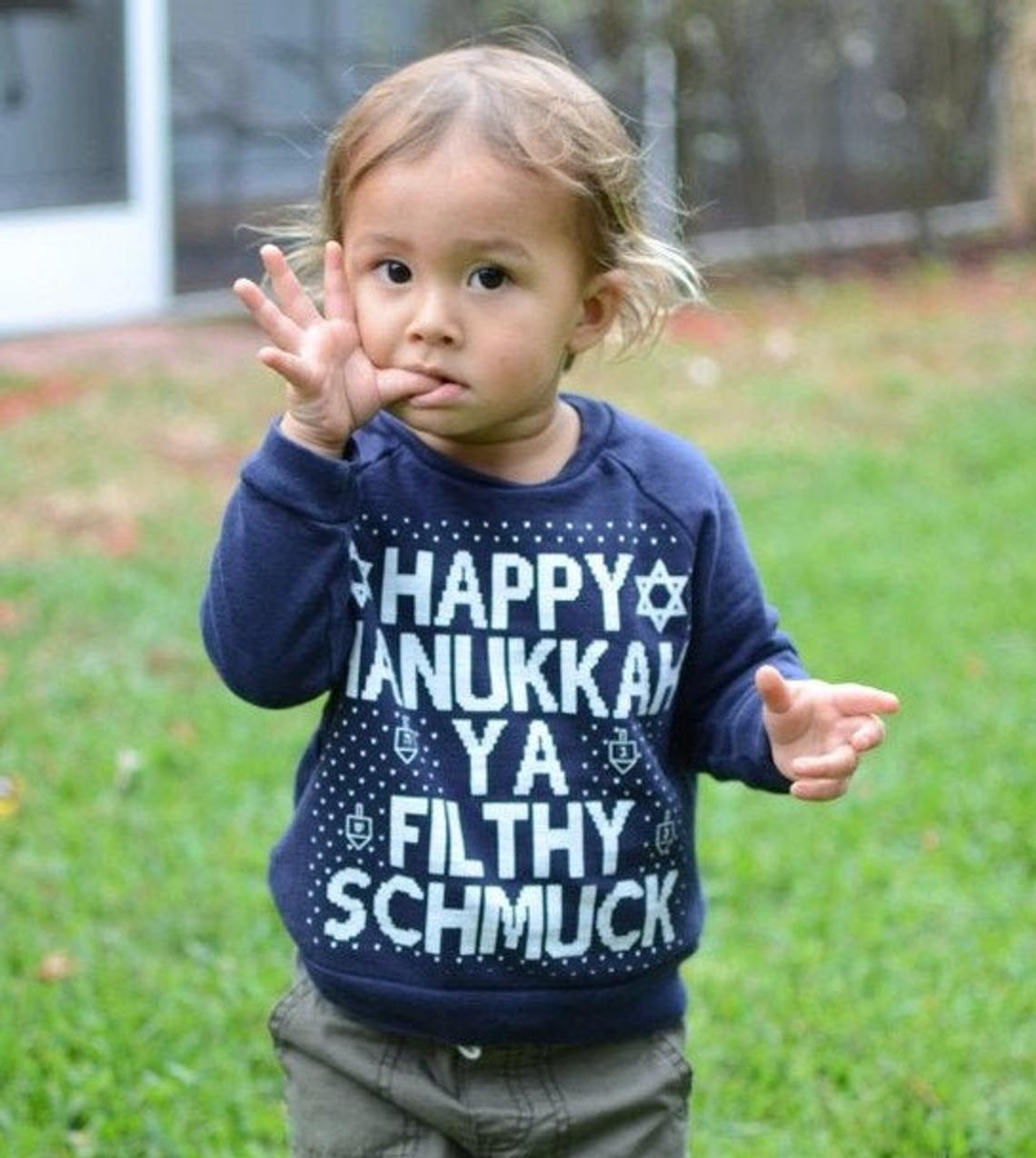 child wearing Hanukkah sweater