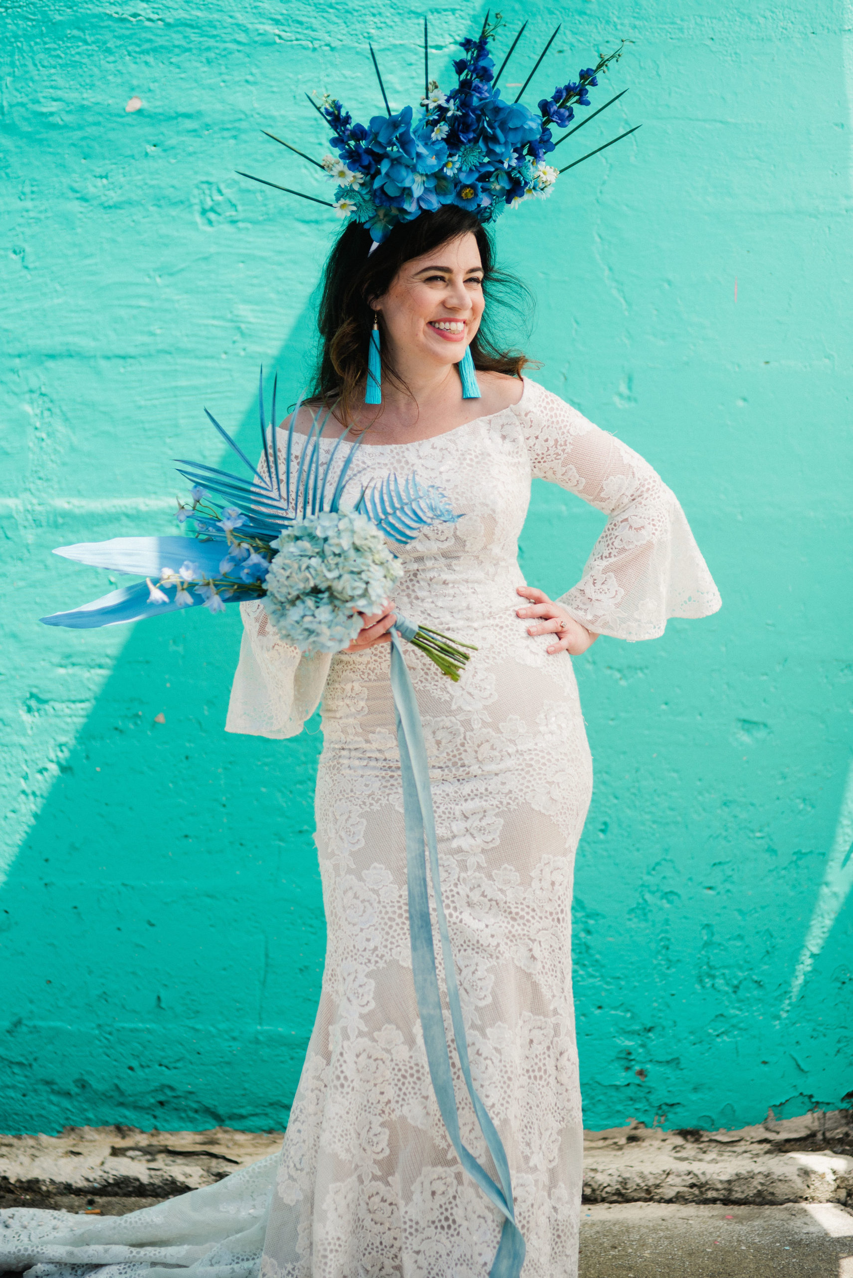 woman wearing wedding dress with blue accessories