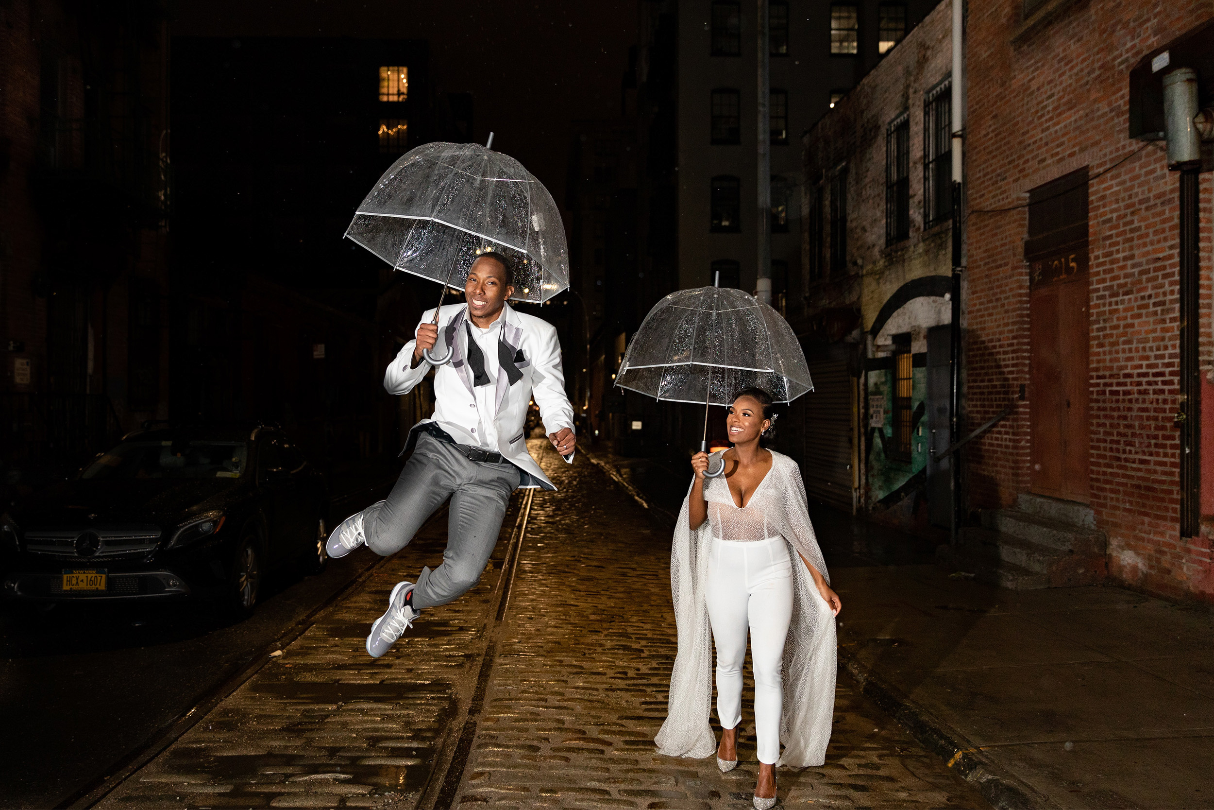 man and woman walking in the rain in wedding attire